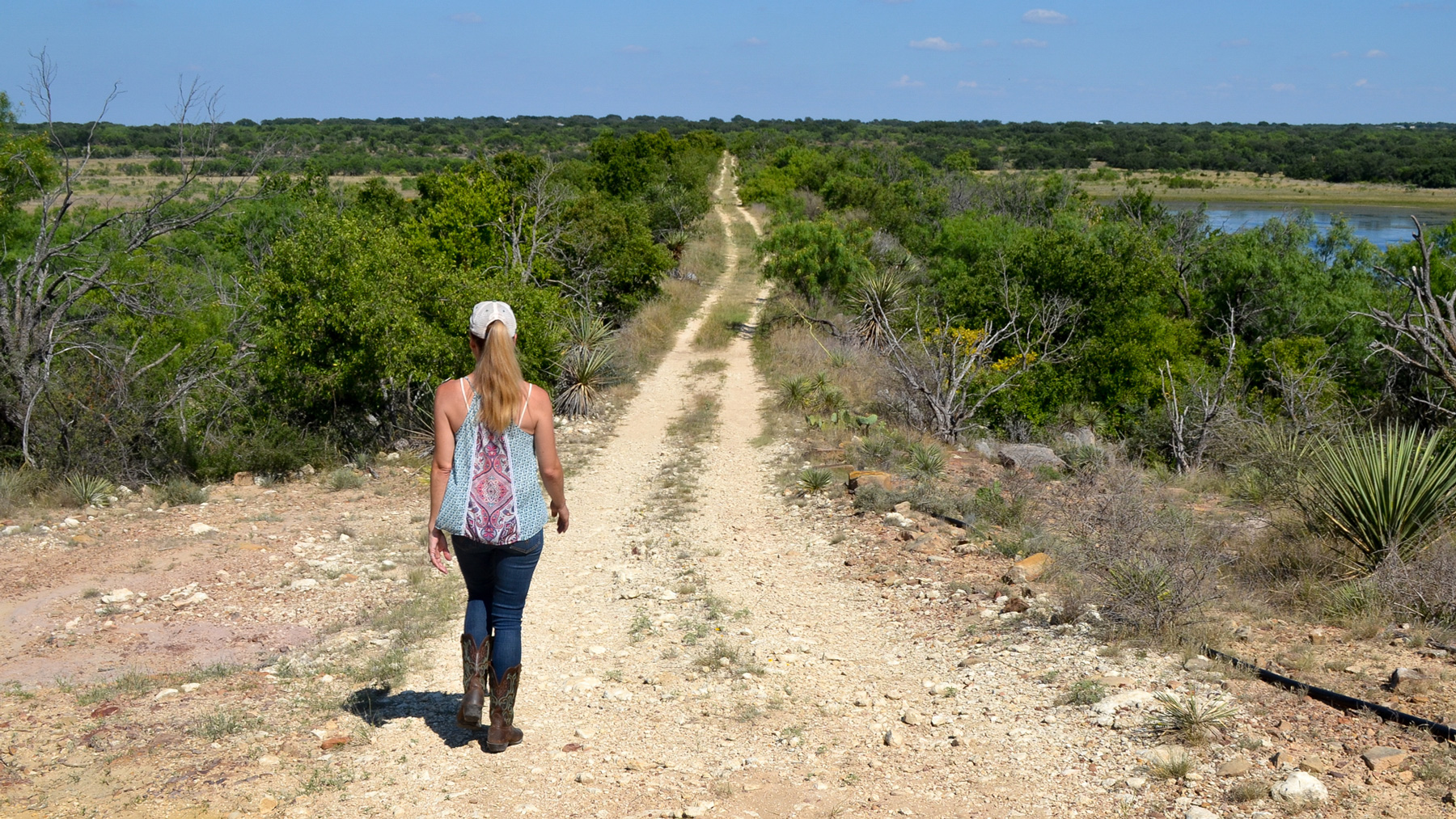 Beef farmer Amy Greer walks along the property line of her ranch in Brady, Texas. Her family is working with city officials to prepare easements for a new water system. (Elizabeth Sims/News21)
