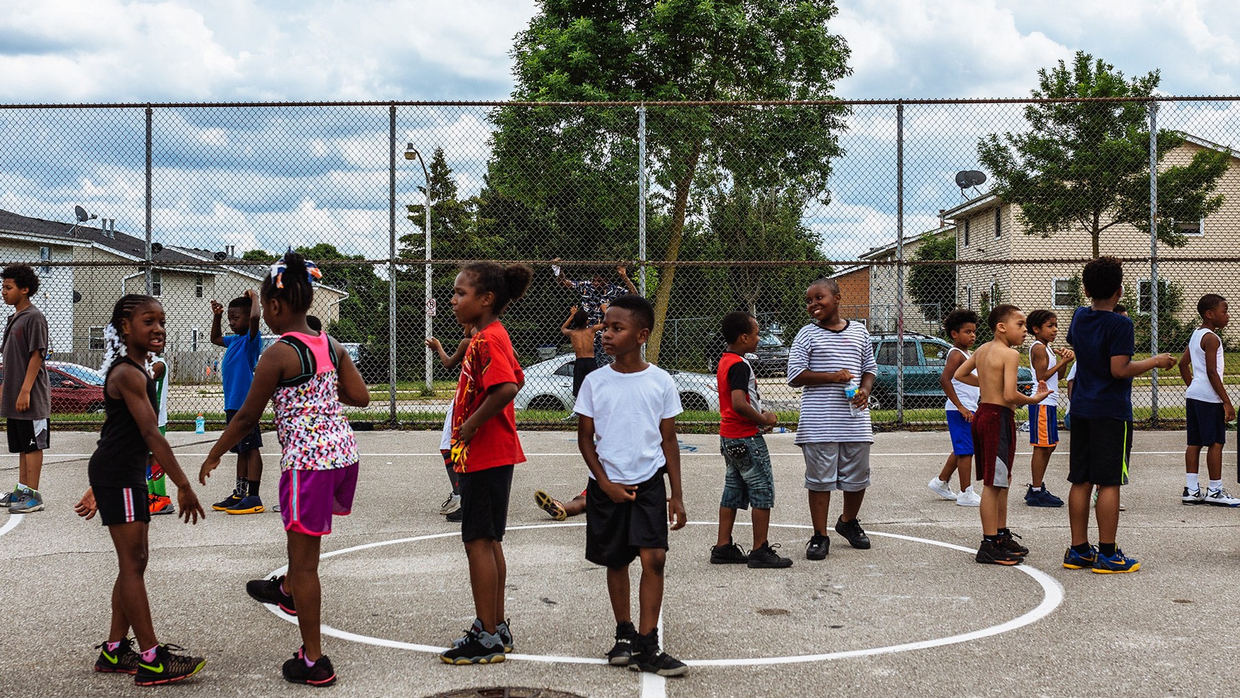 Children from the north side of Milwaukee line up for basketball practice in the first junior basketball league day of the summer. (Michael M. Santiago/News21)