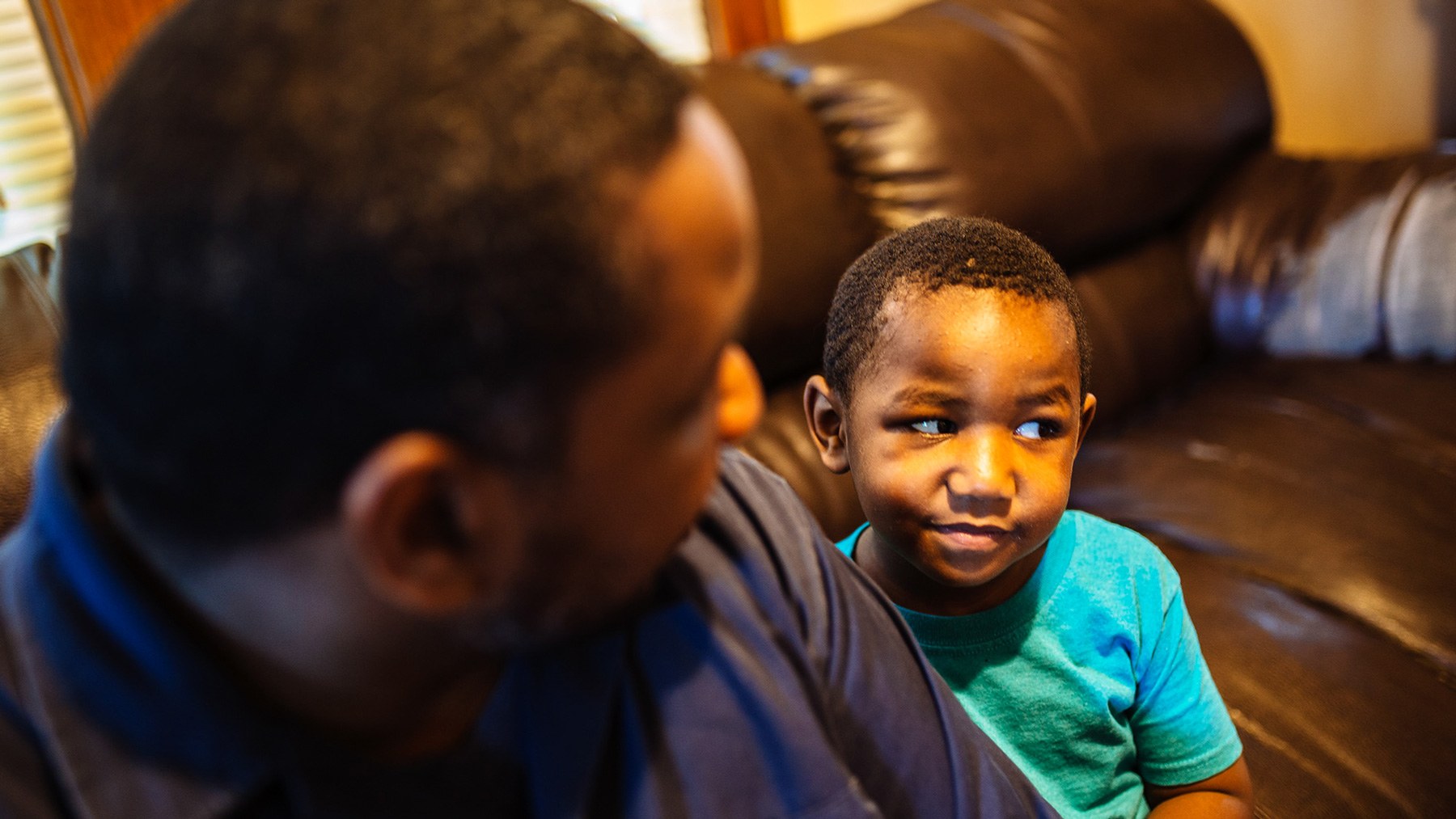Tory Lowe and his 4-year-old son, Troy, sit in their Milwaukee home. In December, Tory learned that his son had lead poisoning. (Michael M. Santiago/News21)