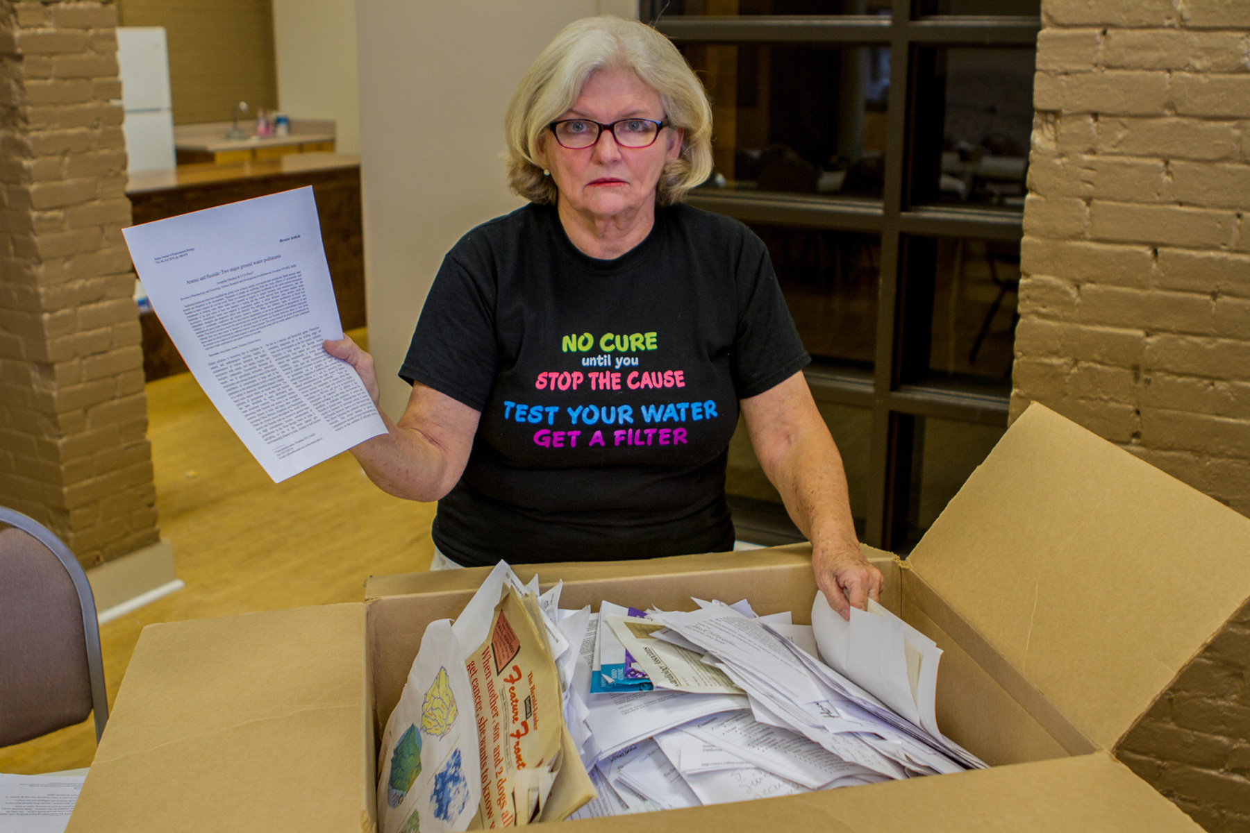 Georgia resident Janet McMahan sorts through documents she’s been collecting since her son died in 2014. She believes his death was caused by arsenic found in her family’s well water. (Brandon Kitchin/News21)